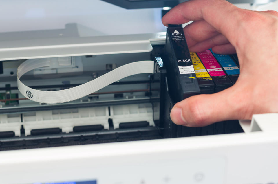 Person using an inkjet printer