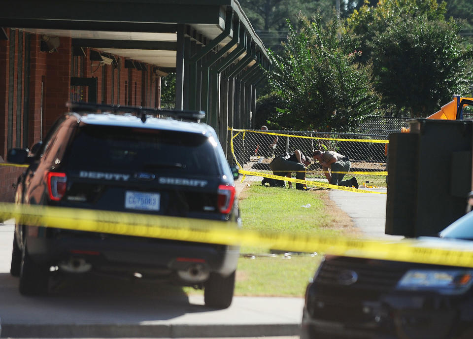 <p>Members of law enforcement investigate an area at Townville Elementary School on Wednesday, Sept. 28, 2016, in Townville, S.C. A teenager opened fire at the South Carolina elementary school Wednesday, wounding two students and a teacher before the suspect was taken into custody, authorities said. (AP Photo/Rainier Ehrhardt) </p>