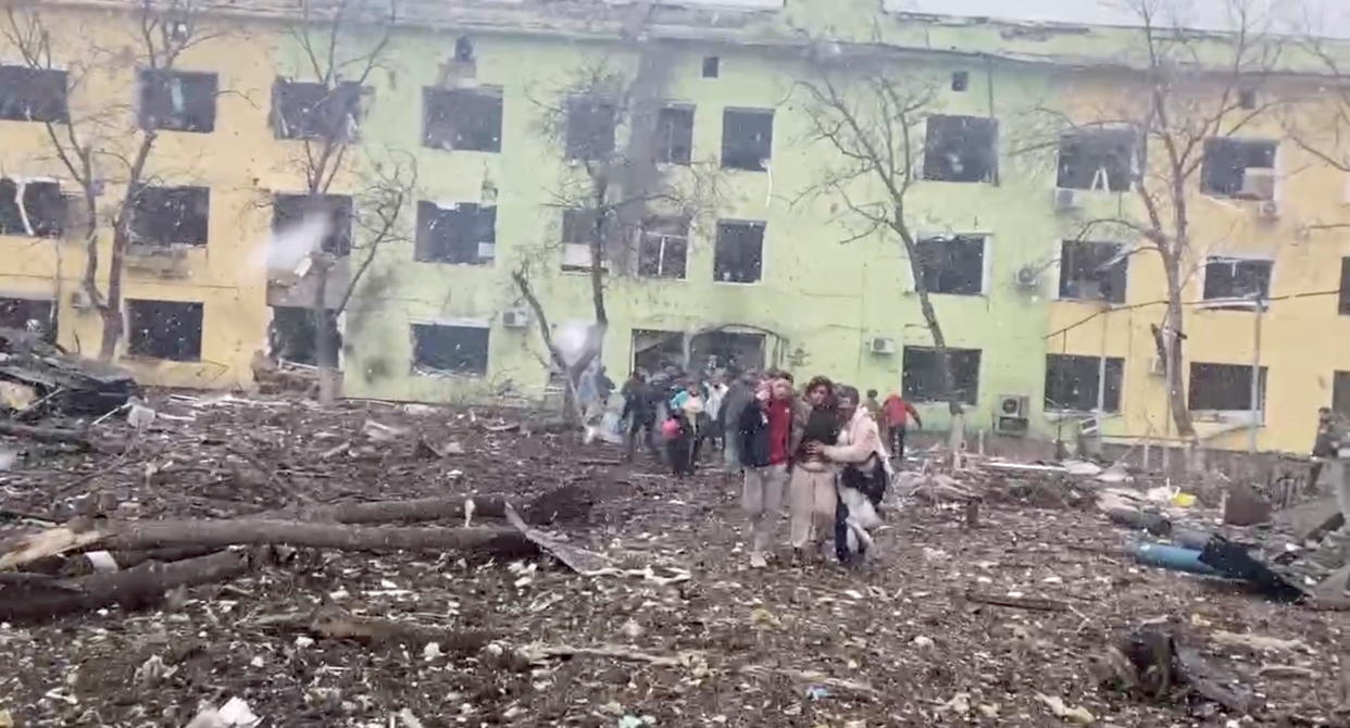 A person is carried out after the destruction of Mariupol children's hospital as Russia's invasion of Ukraine continues, in Mariupol, Ukraine, March 9, 2022 in this still image from a handout video obtained by Reuters. Ukraine Military/Handout via REUTERS    THIS IMAGE HAS BEEN SUPPLIED BY A THIRD PARTY.