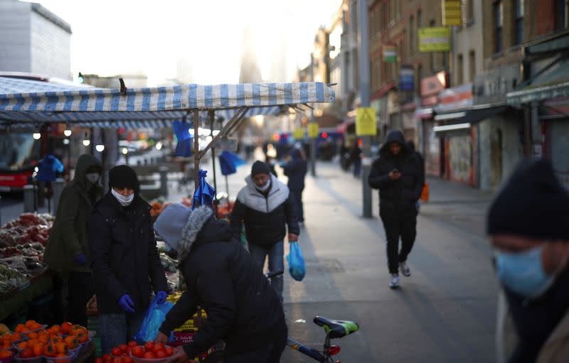 People shop at a market stalls, amid the coronavirus disease (COVID-19) outbreak, in east London