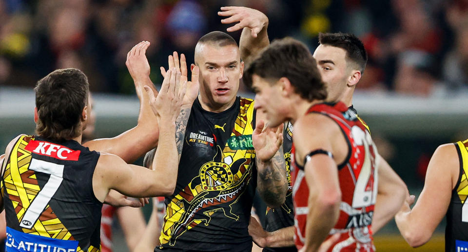 Seen here, Dustin Martin is mobbed by Richmond teammates during his side's AFL clash against Essendon. 