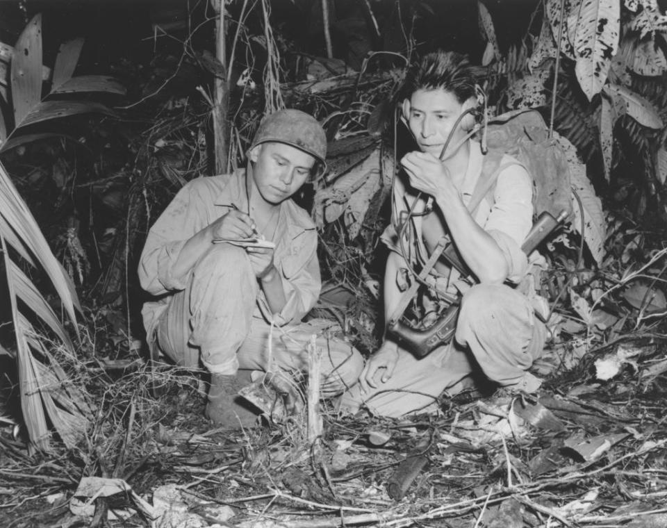 view of corporal henry bake, jr, left, and private first class george kirk, navajo indians serving with a marine signal unit, as they operate a portable radio set in a clearing theyve hacked in the dense jungle close behind the front lines on the island of bougainville, papua new guinea, december 1943 photo by usmcinterim archivesgetty images