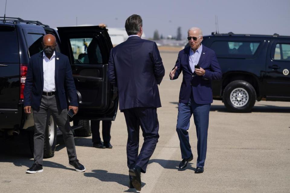 Joe Biden talks with California Gov. Gavin Newsom as he arrived in the state on Monday to survey wildfire damage.