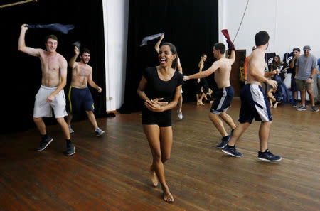 A dancer with Cuba's National Ballet School (C) jokes with players from Rice University's baseball team, which had to cancel four of their five exhibition games against Cuban professional teams when Fidel Castro died during their visit here, in Havana, Cuba, December 1, 2016. REUTERS/Stringer