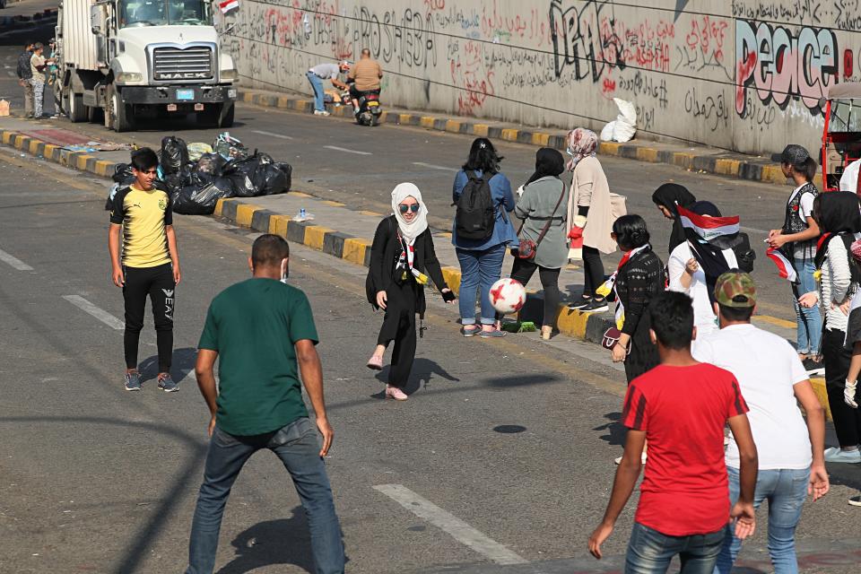 Protesters play football during ongoing anti-government demonstrations, in Baghdad, Iraq, Thursday, Oct. 31, 2019. (AP Photo/Hadi Mizban)
