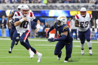 New England Patriots quarterback Mac Jones (10) runs past Los Angeles Chargers outside linebacker Kyzir White (44) during the first half of an NFL football game Sunday, Oct. 31, 2021, in Inglewood, Calif. (AP Photo/John McCoy)