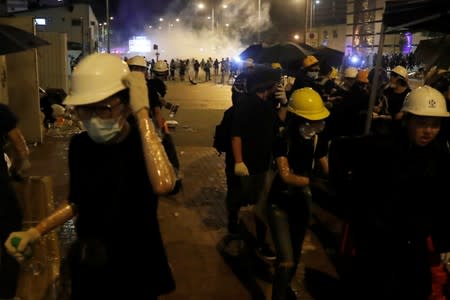 Protesters react after tear gas was fired by police outside the Legislative Council building, after demonstrators stormed the building on the anniversary of Hong Kong's handover to China in Hong Kong