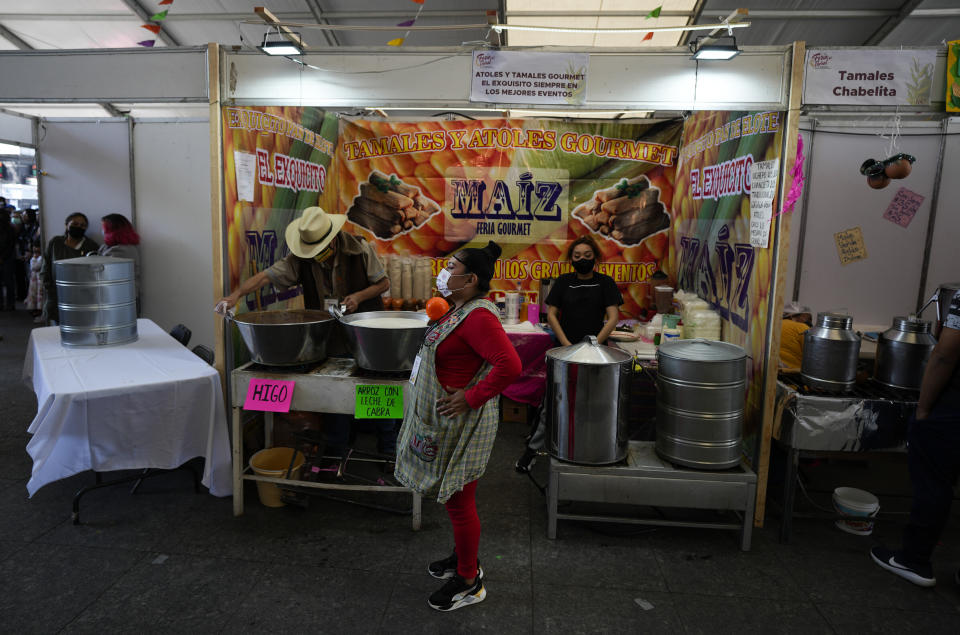 Vendors wait for clients before the opening of the tamales fair in the Ixtapalapa neighborhood of Mexico City, Friday, Jan. 27, 2023. Some vendors also known to slowly pedal big tricycles down streets offering tamales, which can also be wrapped in banana leaves or other foliage. (AP Photo/Fernando Llano)