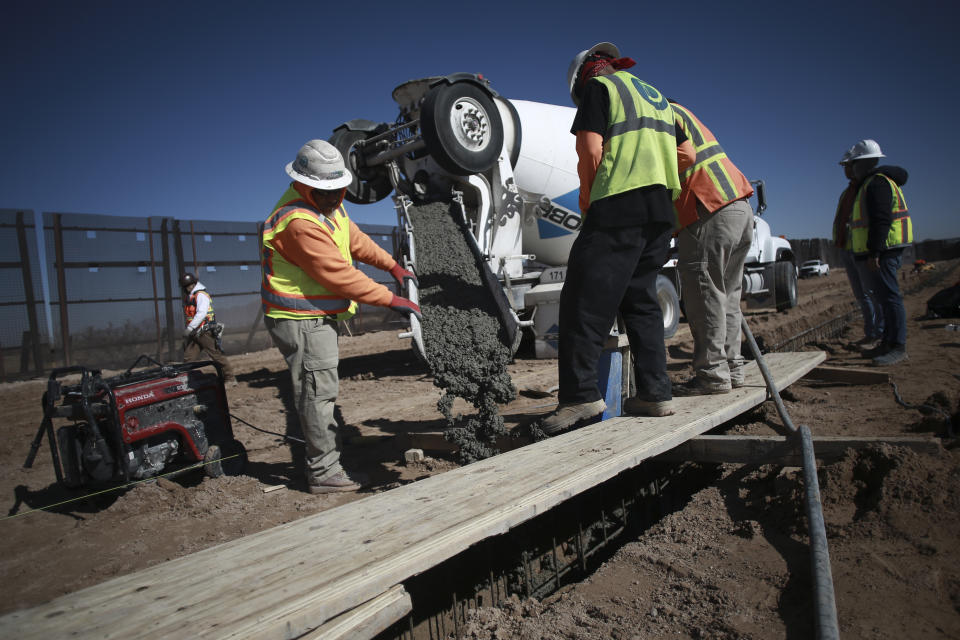 FILE - In this Jan. 12, 2021, file photo, workers prepare the foundation for a steel section of border wall that will be built on the Mexican side of older metal fencing dividing Ciudad Juarez, Mexico from Sunland Park, New Mexico, on the outskirts of Ciudad Juarez, Mexico. Immigrant rights activists energized by a new Democratic administration and majorities on Capitol Hill are gearing up for a fresh political battle. A coalition of national advocacy groups on Monday announced a multimillion-dollar campaign to help push through President Joe Biden’s plan to open a citizenship pathway for up to 11 million people. (AP Photo/Christian Chavez, File)