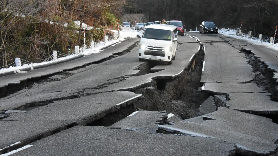 Cars are stranded in the cracks as the road has been damaged by multiple strong earthquakes on January 2, 2024 in Noto, Ishikawa, Japan. - The Asahi Shimbun/Getty Images