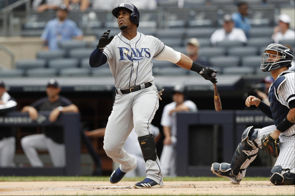 Tampa Bay Rays' Yandy Diaz, left, and New York Yankees' catcher Gary Sanchez watch Diaz's home run during the first inning of the first game of a baseball doubleheader, Thursday, July 18, 2019, in New York. (AP Photo/Kathy Willens)