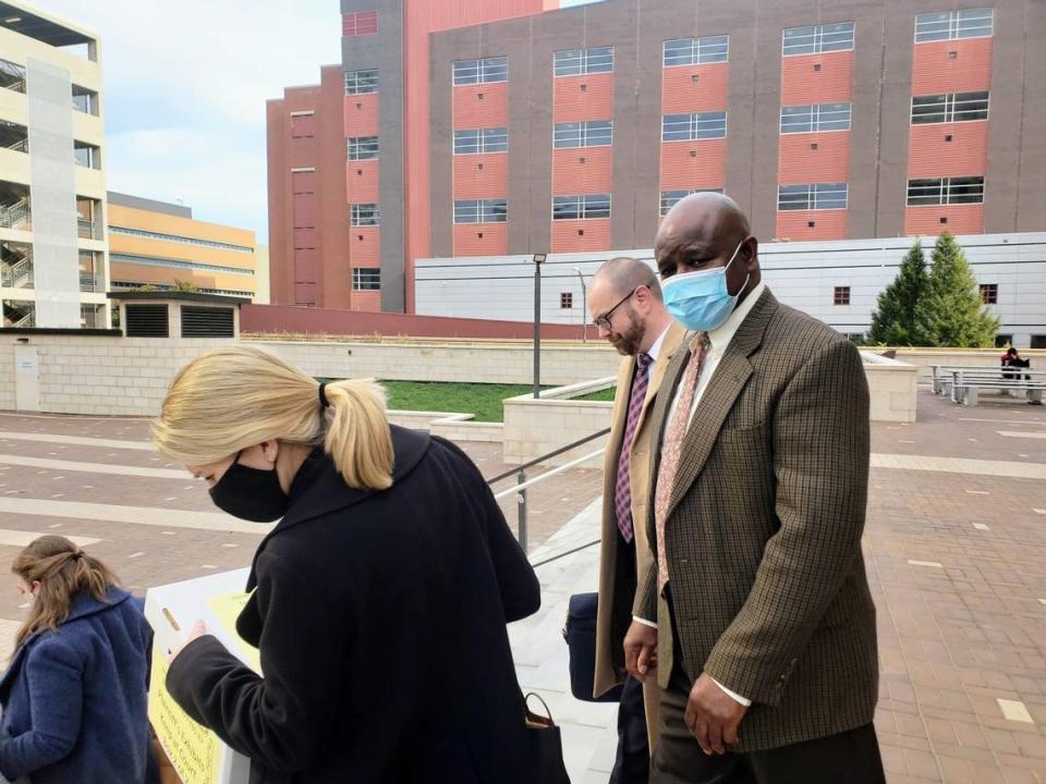 Retired Durham Police Detective Darrell Dowdy walks out of the courtroom on Dec. 1, 2021 with his attorneys after a federal jury found he fabricated evidence and performed an inadequate investigation into a 1991 double murder that resulted in Darryl Howard spending 23 years in behind bars