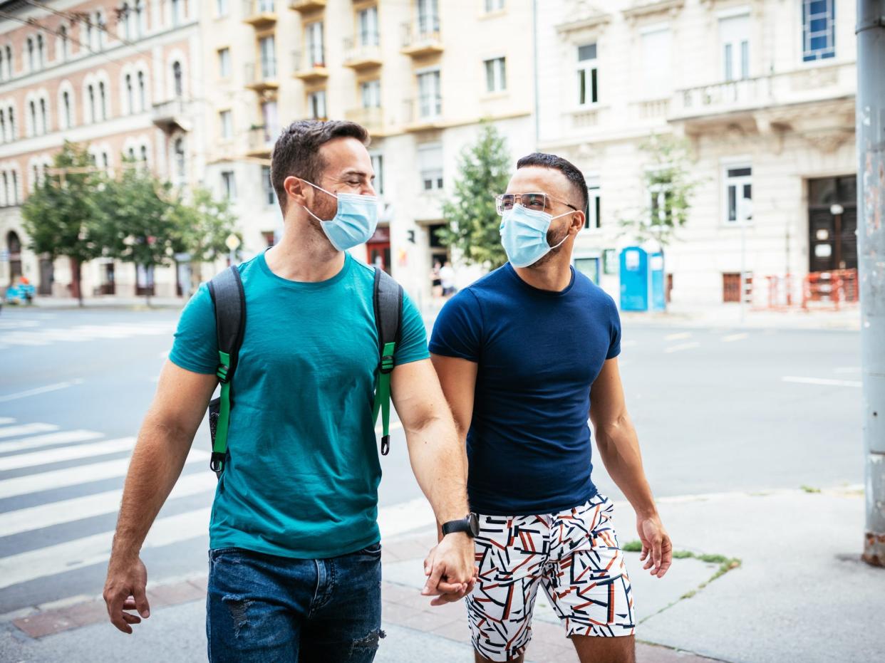 queer couple in masks COVID-19