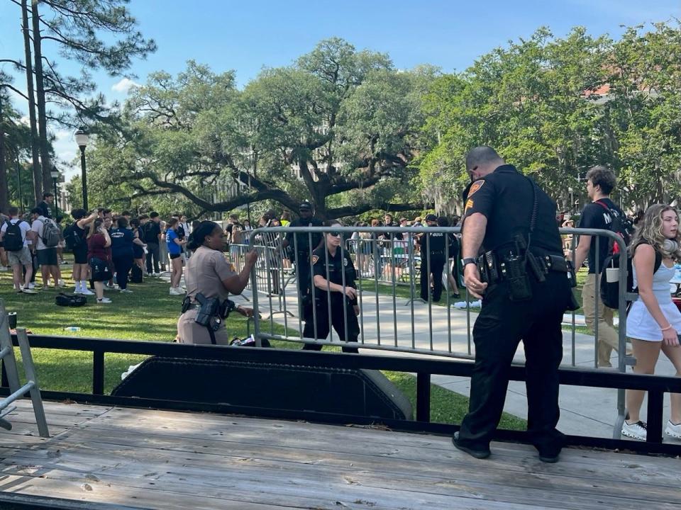 FSU Police officers put down barricades on either sides of a sidewalk to keep Pro-Palestinian and Pro-Israel protesters separated.