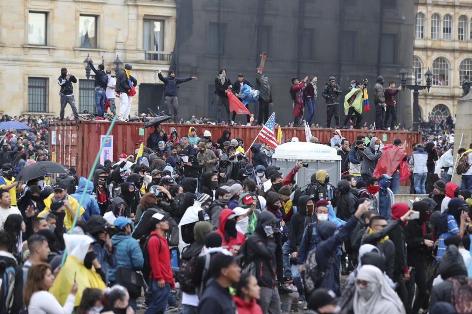 Anti-government protesters shout at the police during a nationwide strike, at Bolivar square in downtown Bogota, Colombia, Thursday, Nov. 21, 2019. Colombia's main union groups and student activists called for a strike to protest the economic policies of Colombian President Ivan Duque government and a long list of grievances. (AP Photo/Fernando Vergara)