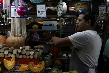 Information for Vippo app is seen in a fruit and vegetables stall at Chacao Municipal Market in Caracas, Venezuela January 19, 2018. REUTERS/Marco Bello