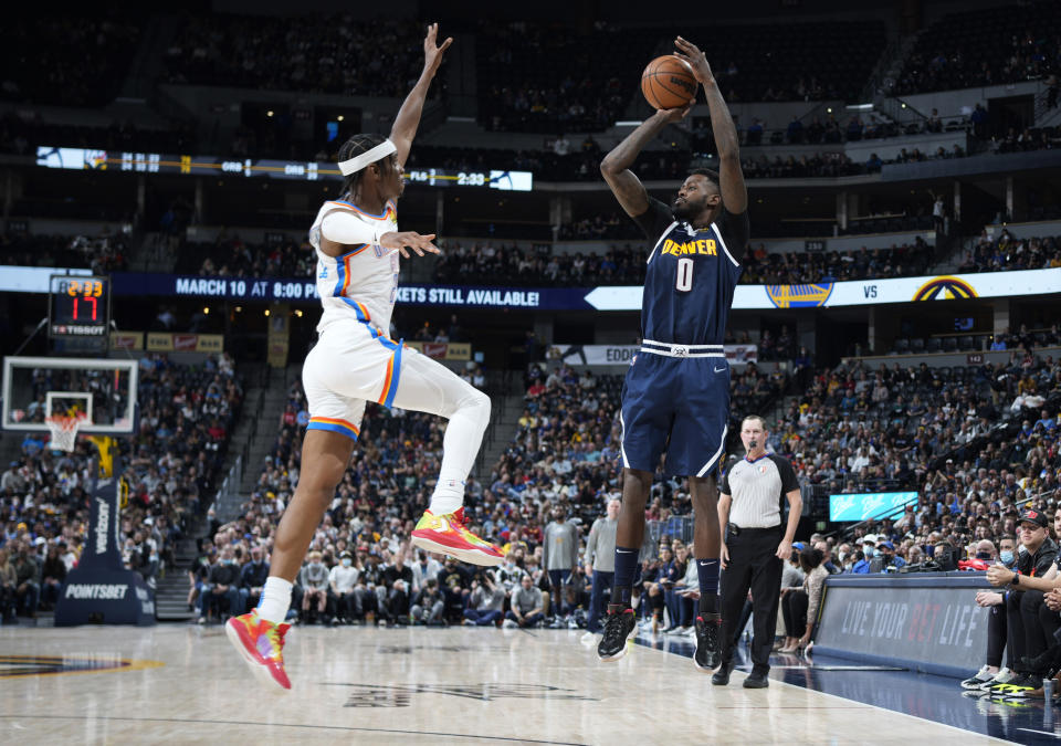 Denver Nuggets forward JaMychal Green, right, shoots as Oklahoma City Thunder guard Shai Gilgeous-Alexander defends during the second half of an NBA basketball game Wednesday, March 2, 2022, in Denver. The Thunder won 119-107. (AP Photo/David Zalubowski)