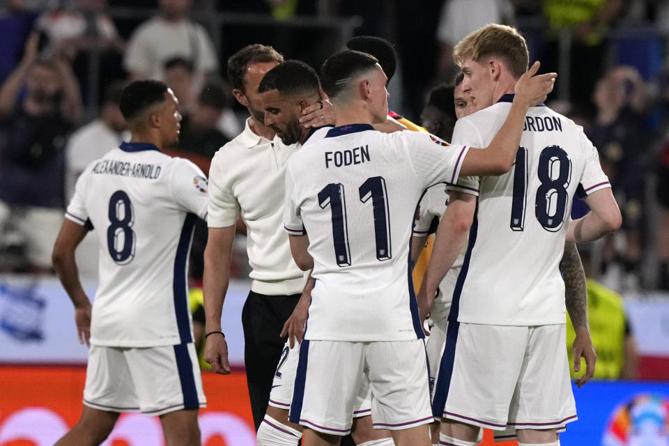 England team members congratulate each other after a Group C match between the England and Slovenia at the Euro 2024 soccer tournament in Cologne, Germany, Tuesday, June 25, 2024. (AP Photo/Frank Augstein)