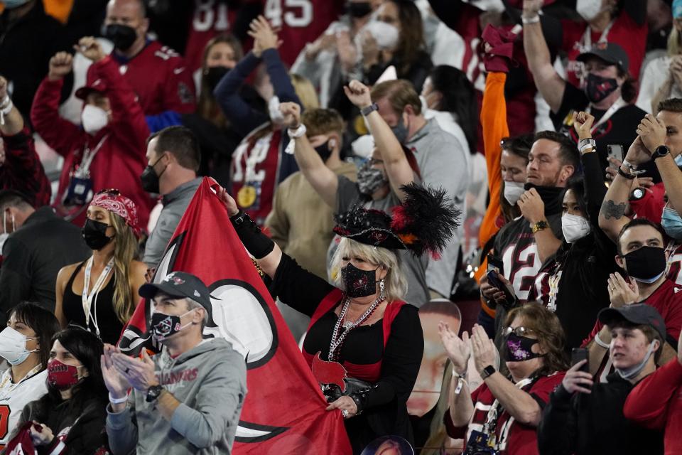 Fans cheer before the first half of the NFL Super Bowl 55 football game between the Kansas City Chiefs and the Tampa Bay Buccaneers, Sunday, Feb. 7, 2021, in Tampa, Fla. (AP Photo/Ashley Landis)