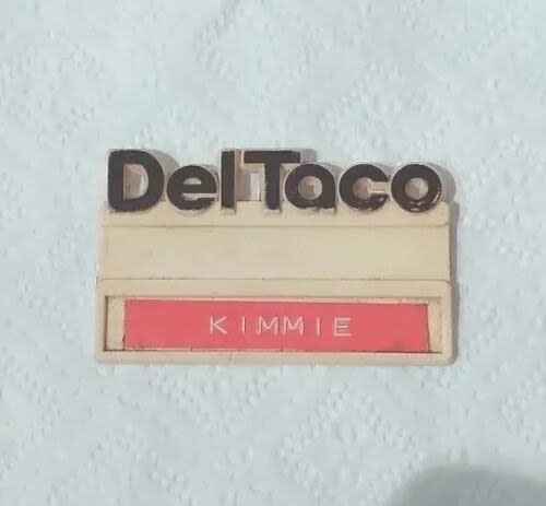A Del Taco name badge with the name "KIMMIE" displayed on it
