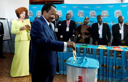 Cameroonian President Paul Biya casts his ballot while his wife Chantal watches during the presidential election in Yaounde, Cameroon October 7, 2018. REUTERS/Zohra Bensemra