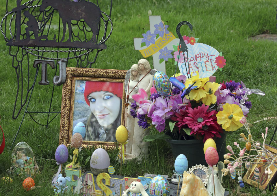 An arrangement of photos, flowers and Easter eggs surrounds the grave of Tanna Jo Fillmore on Friday, April 26, 2019, in Salt Lake City. Fillmore, who had a history of mental problems, killed herself in Duchesne County jail in 2016 while locked up on a probation violation. She told her mother she was being denied her prescription medicines that had stabilized her. (AP Photo/Rick Bowmer)