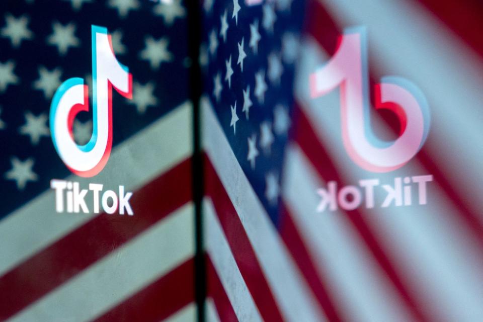 This photo illustration shows the TikTok logo reflected in an image of the US flag, in Washington, DC, on March 16, 2023. - China urged the United States to stop 