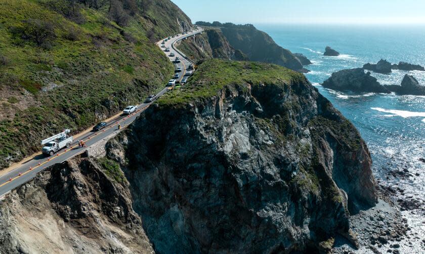Big Sur, CA - April 02: A convoy of vehicles are led through a closed section of Hwy. 1 as Caltrans crews assess damage after the road slipped out south of the Rocky Creek Bridge on Tuesday, April 2, 2024 in Big Sur, CA. (Brian van der Brug / Los Angeles Times)