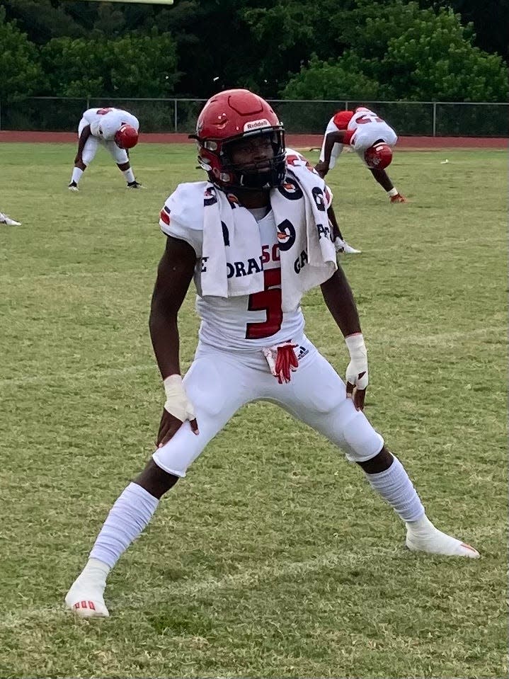 Miami Edison wide receiver Nathaniel Joseph stretches before playing at Deerfield Beach on Aug. 27, 2021