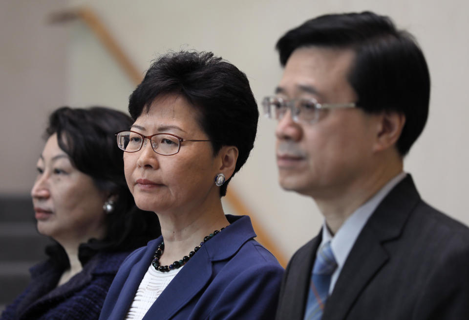 Hong Kong Secretary for Security John Lee, right, Hong Kong Chief Executive Carrie Lam, center, and Secretary of Justice Teresa Cheng listen to reporters questions during a press conference in Hong Kong Monday, June 10, 2019. Lam signaled Monday that her government will go ahead with proposed amendments to its extradition laws after a massive protest against them. (AP Photo/Vincent Yu)