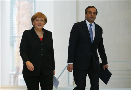 German Chancellor Angela Merkel (L) and Greece's Prime Minister Antonis Samaras arrive at a news conference after talks at the Chancellery in Berlin, November 22, 2013. REUTERS/Thomas Peter