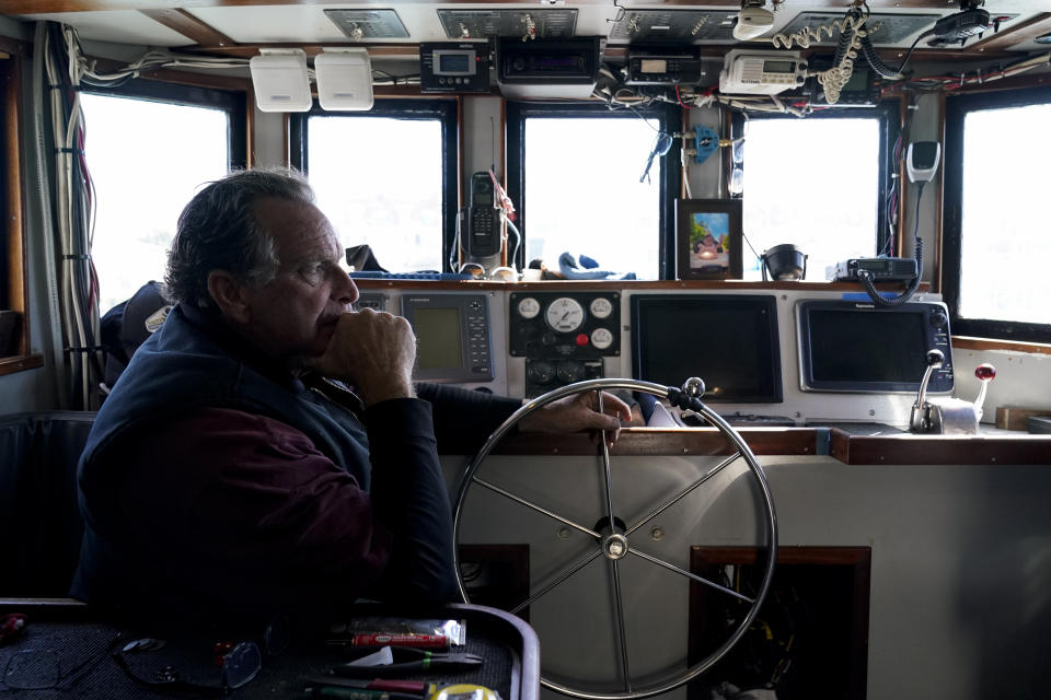 Bob Maharry sits inside his fishing boat docked at Pier 45 in San Francisco, Monday, March 20, 2023. This would usually be a busy time of year for Maharry and his crew as salmon fishing season approaches. On April 7, the Pacific Fishery Management Council, the regulatory group that advises federal officials, will take action on what to do about the 2023 season for both commercial and recreational salmon fishing. (AP Photo/Godofredo A. Vásquez)