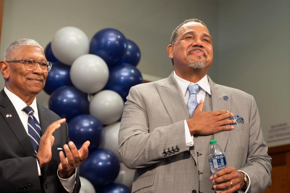 Georgetown University Director of Intercollegiate Athletics Lee Reed, left, introduces their new men's NCAA college basketball head coach Ed Cooley, right, in Washington, Wednesday, March 22, 2023. (AP Photo/Cliff Owen)