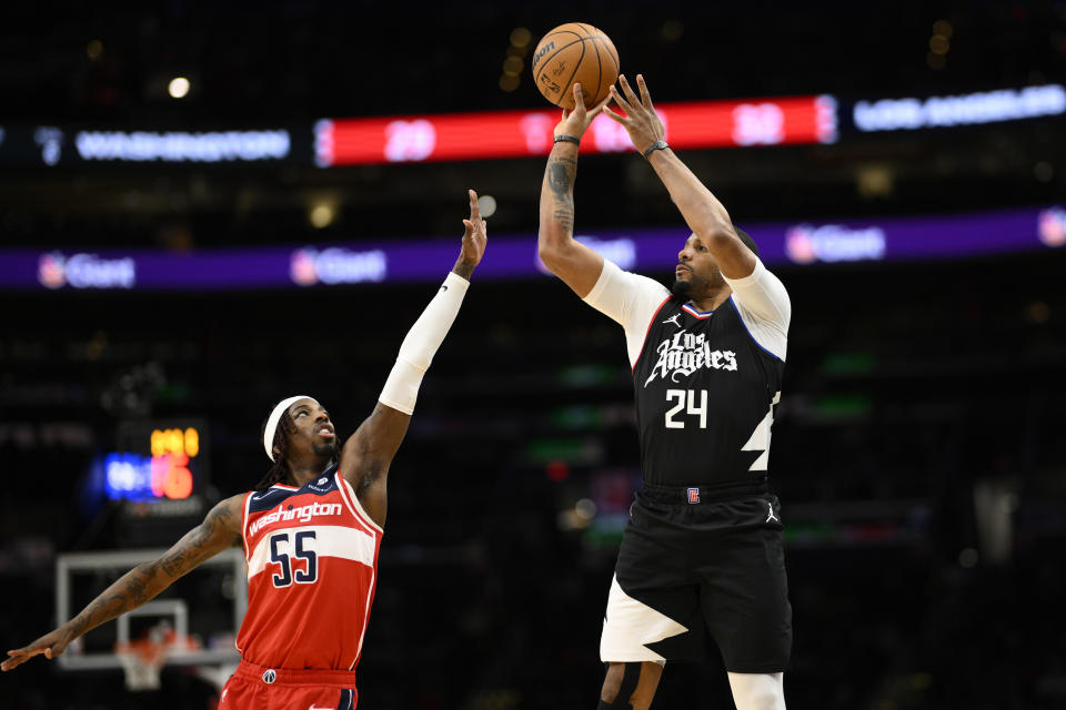 Los Angeles Clippers guard Norman Powell (24) shoots against Washington Wizards guard Delon Wright (55) during the first half of an NBA basketball game, Wednesday, Jan. 31, 2024, in Washington. (AP Photo/Nick Wass)