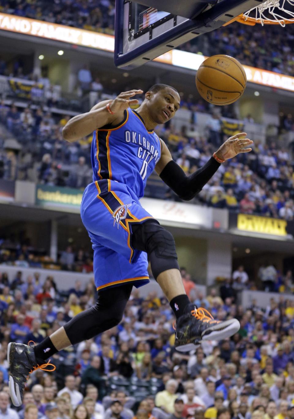 Oklahoma City Thunder guard Russell Westbrook comes down after a dunk against the Indiana Pacers in the second half of an NBA basketball game in Indianapolis, Sunday, April 13, 2014. (AP Photo/Michael Conroy)