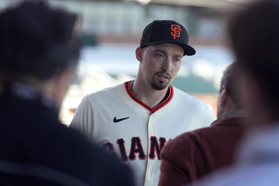 New San Francisco Giants pitcher Blake Snell speaks to agent Scott Boras after Blake was introduced during a baseball news conference, Wednesday, March 20, 2024, in Scottsdale, Ariz. (AP Photo/Ross D. Franklin)