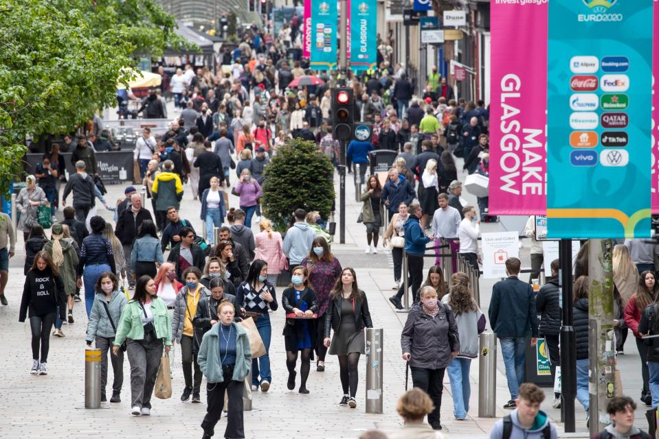 <p>Glaswegians will be able to drink alcohol indoors, meet in private residences, and hug loved ones from the weekend</p> (PA)