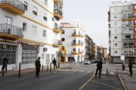 Spanish legionnaires patrol an empty street in downtown Ronda