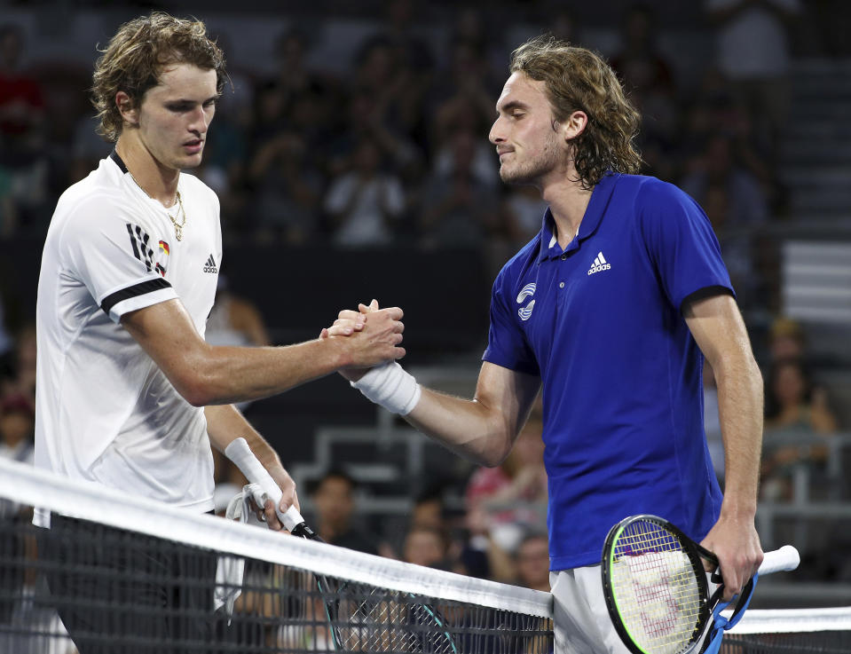 Stefanos Tsitsipas of Greece, right, shakes hands with Alexander Zverev of Germany, left, after winning their match, at the ATP Cup tennis tournament in Brisbane, Australia, Sunday, Jan. 5, 2020. (AP Photo/Tertius Pickard)