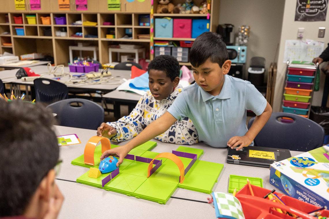 Students Jamal Petty and Angel Nava program a robotic mouse to run a course during fifth-grade STEM class at David L. Walker Elementary in Crowley ISD on Feb. 7. The new Accelerated Learning Academy at Walker extends the school year to prevent learning loss.