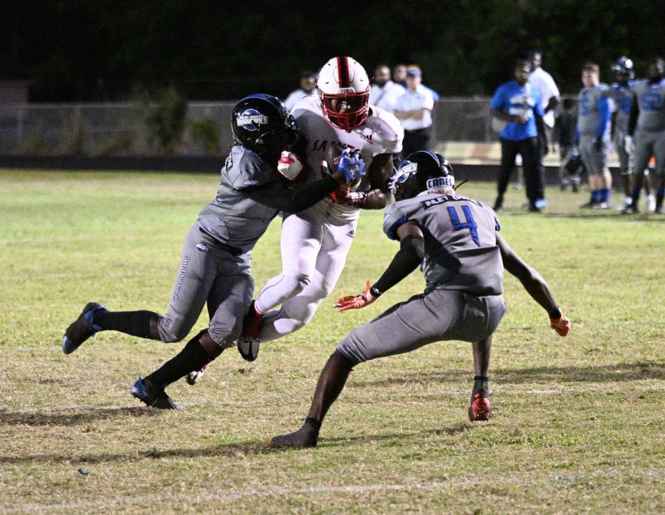 The Inlet Grove football team celebrates its victory over Palm Beach Christian Prep on Thursday, Nov. 3, 2022 in Riviera Beach. The win pushed the Hurricanes' record to 7-2 ahead of the FHSAA playoffs.