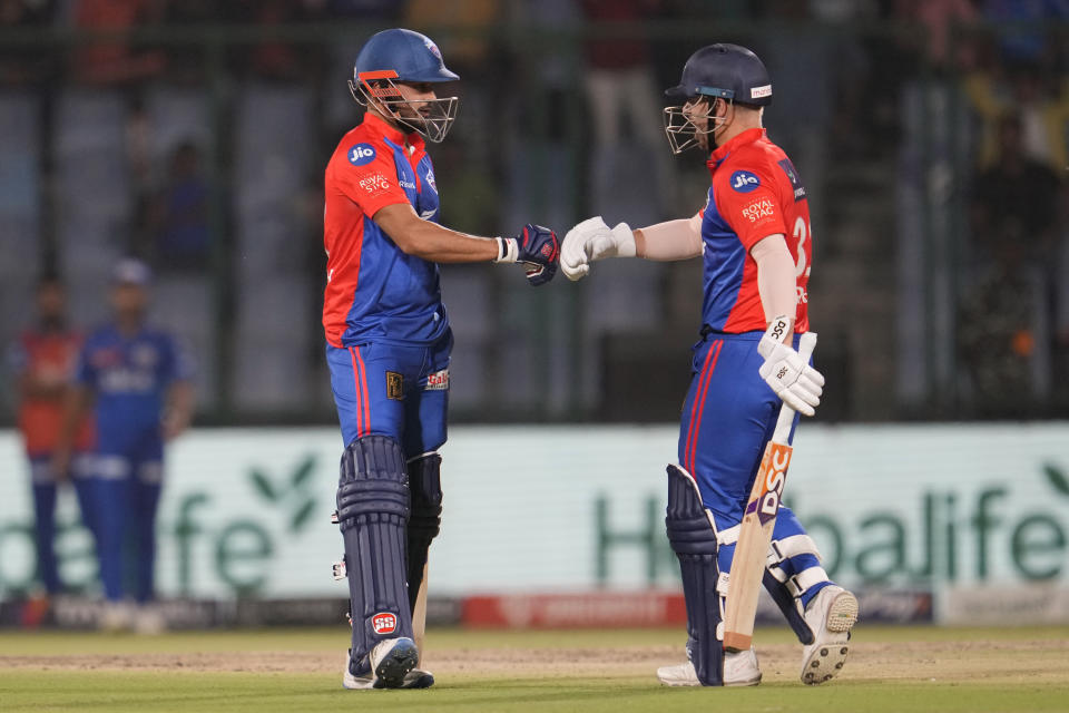 Delhi Capitals' David Warner and Manish Pandey celebrate a boundary by Warner during the Indian Premier League (IPL) match between Delhi Capitals and Mumbai Indians in New Delhi, India, Tuesday, April 11, 2023. (AP Photo/Manish Swarup)