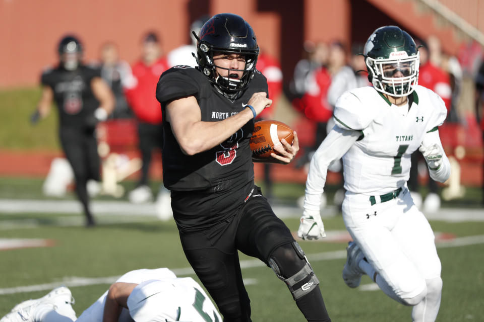 In this Nov. 9, 2019 photo, provided by North Central College Athletics, North Central quarterback Broc Rutter carries the ball against Illinois-Wesleyan during an NCAA college football game in Naperville, Ill. Rutter was selected to the Division III All-America first team on Thursday, Dec. 19, 2019. (Steve Woltmann/North Central College Athletics via AP)
