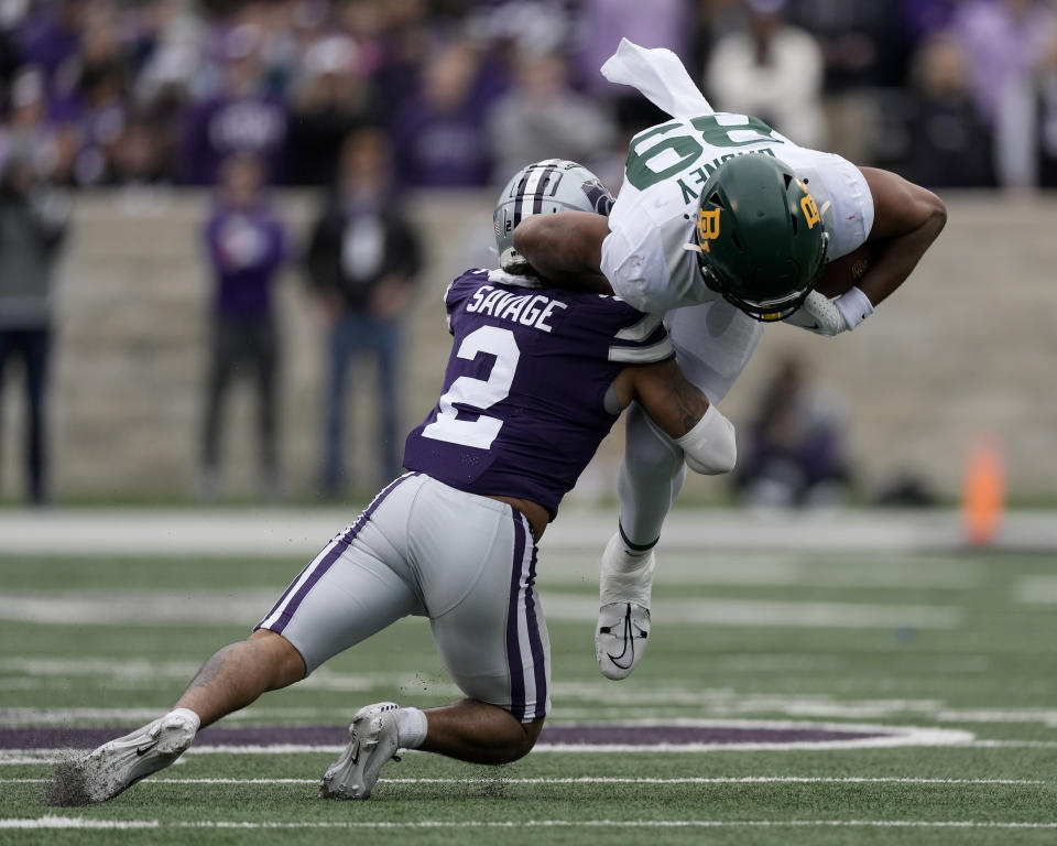 Baylor tight end Drake Dabney (89) is tackled by Kansas State safety Kobe Savage (2) during the first half of an NCAA college football game Saturday, Nov. 11, 2023, in Manhattan, Kan. (AP Photo/Charlie Riedel)