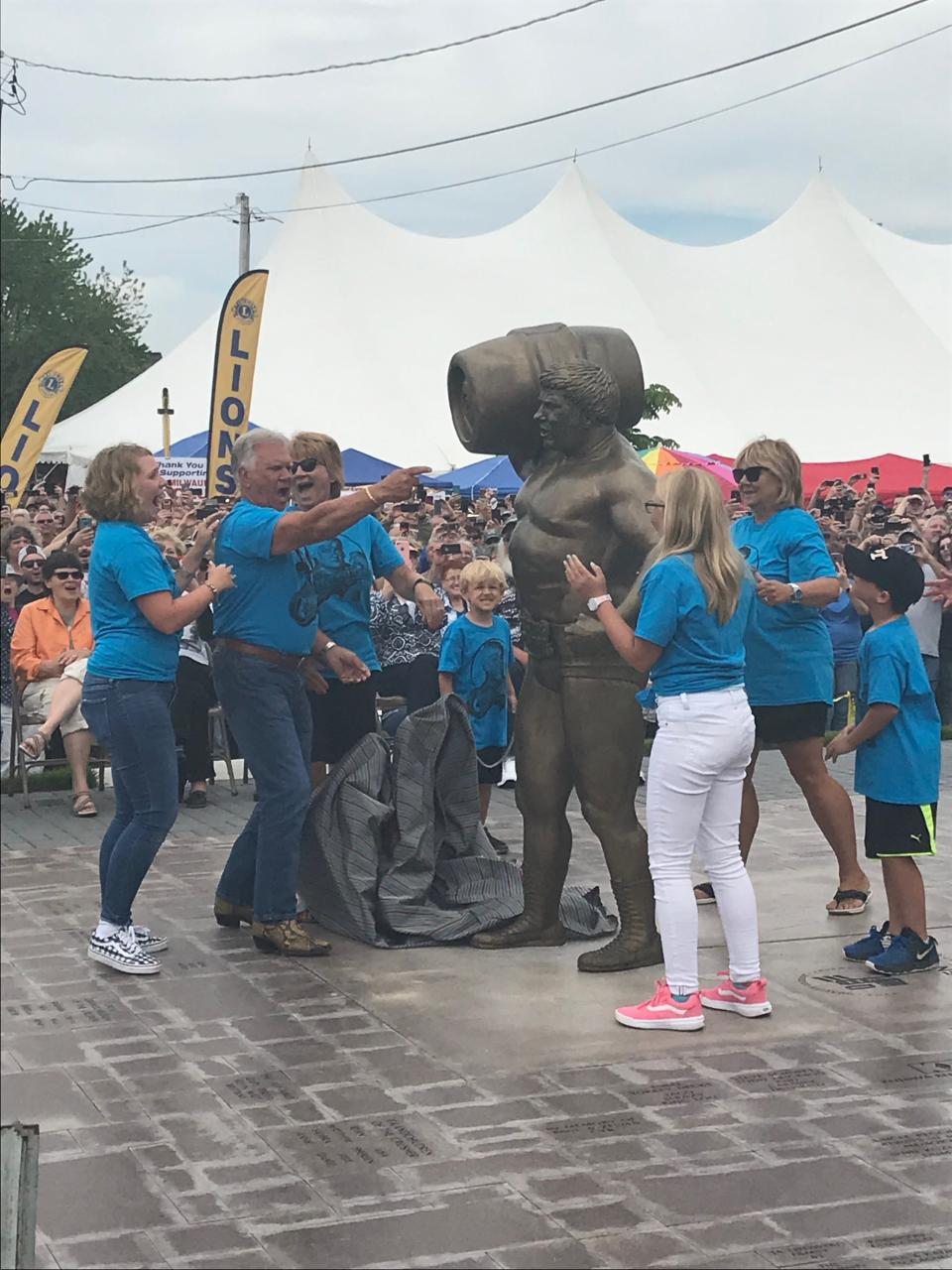 The Lisowski family unveils the life-size statue of Reggie "Da Crusher" Lisowski at Crusherfest in South Milwaukee on June 8, 2019.