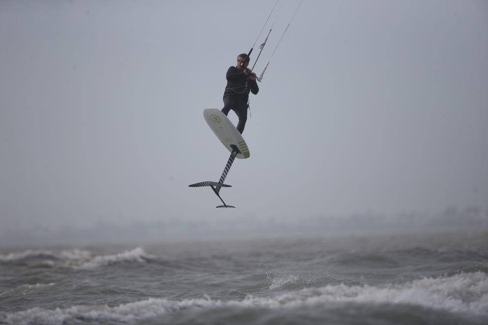 A strong line of storms moved through Florida Tuesday, bringing with it strong winds and tornadoes. Kiteboarders and visitors were seen on Fort Myers Beach ahead of the storms.