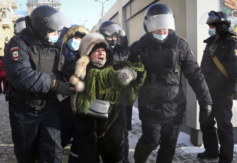 Police detain a woman during a protest against the jailing of opposition leader Alexei Navalny in Siberian city of Omsk, Russia, Saturday, Jan. 23, 2021. Russian police on Saturday arrested hundreds of protesters who took to the streets in temperatures as low as minus-50 C (minus-58 F) to demand the release of Alexei Navalny, the country's top opposition figure. Navalny, President Vladimir Putin's most prominent foe, was arrested on Jan. 17 when he returned to Moscow from Germany, where he had spent five months recovering from a severe nerve-agent poisoning that he blames on the Kremlin. (AP Photo)