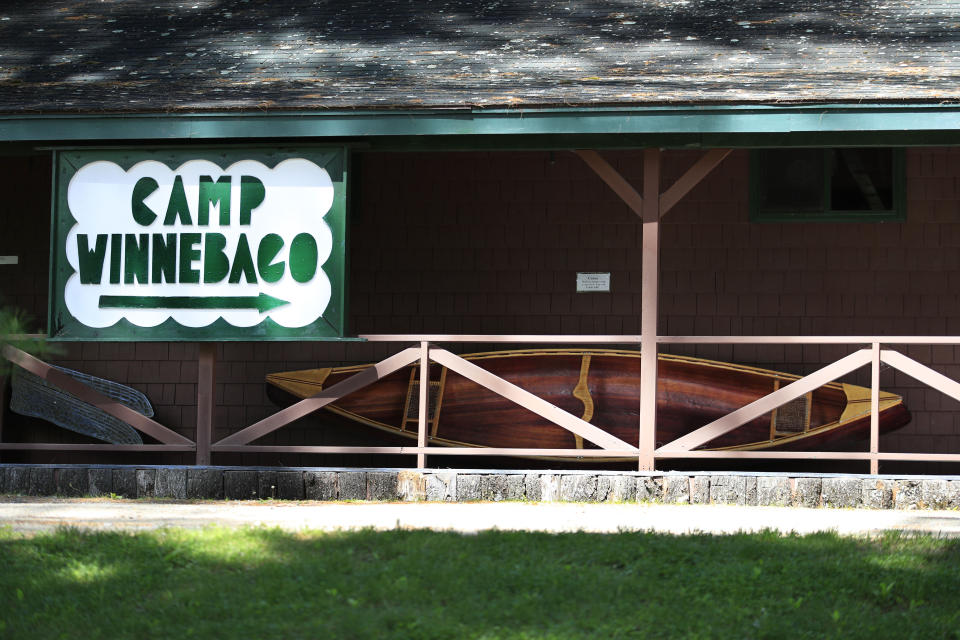 In this Thursday, June 4, 2020 photo, a canoe made by campers and counselors sits outside the museum at the Camp Winnebago summer camp in Fayette, Maine. The boys camp is going ahead with plans to open with a reduction in the number of campers and other changes to comply with guidelines for helping prevent the spread of the coronavirus. Many of the nation's 15,000-plus summer camps opting to close because of health concerns surrounding the pandemic, or because of delays in receiving rules or guidelines from licensing officials. (AP Photo/Robert F. Bukaty)