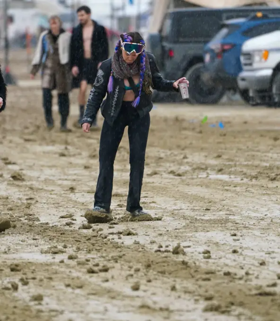 The flooding in Nevada Desert has meant over 70,000 festivalgoers are wading through mud (Trevor Hughes/USA Today)