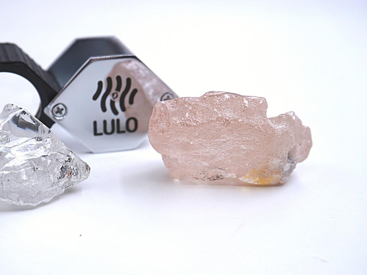 This photo supplied by Lucapa Diamond Company on Wednesday shows the 170 carat pink diamond, right.